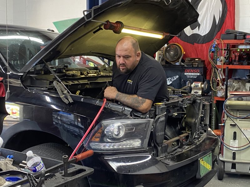 A Harvey's mechanic diagnosing an engine