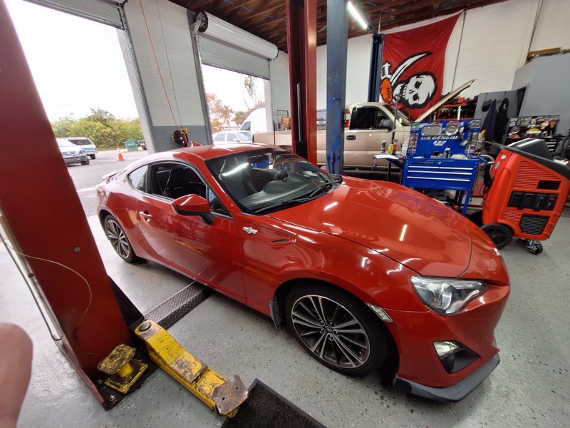 Inside the shop with a car up on the alignment rack